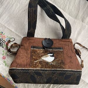 Quilted artisan embroidered Chic-a-dee double handle satchel.